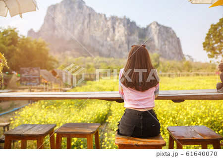 Back view of woman sit in the field of flower. Back view of woman sit in the field of flower. 61640070