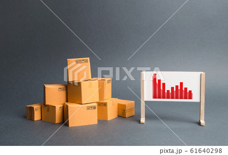Stack of cardboard boxes and a stand with information chart. rate growth of production of goods and products, increasing economic indicators. exports or imports. Increasing consumer demand Stack of cardboard boxes and a stand with information chart. rate growth of production of goods and products, increasing economic indicators. exports or imports. Increasing consumer demand 61640298