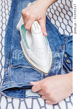 Picture of man ironing jeans Picture of man ironing jeans 61640327