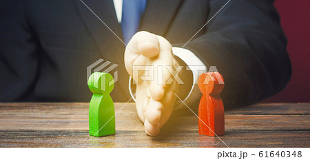 Man divides warring parties conflict with a hand. Mediator services. Stop fight, ceasefire clashes. Finding a compromise. De-escalation of conflict. Avoid the war, start the negotiation process 61640348
