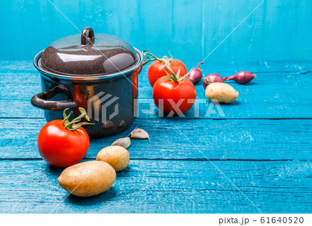 Photo of iron pot for soup, tomato, potatoes, onions 61640520