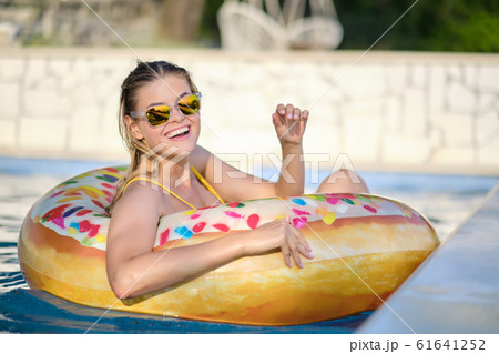 Elegant sexy woman in the white bikini on the Elegant sexy woman in the white bikini on the 61641252