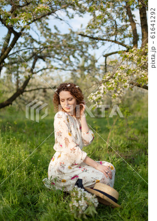 A gorgeous girl walks in a flowering spring A gorgeous girl walks in a flowering spring 61641292