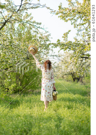 A gorgeous girl walks in a flowering spring A gorgeous girl walks in a flowering spring 61641293