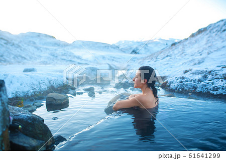 The girl bathes in a hot spring in the open air The girl bathes in a hot spring in the open air 61641299