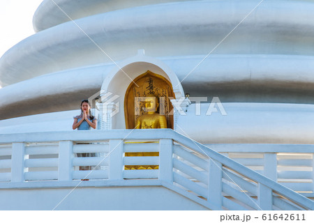 Woman praying at Japanese Peace Pagoda temple in Woman praying at Japanese Peace Pagoda temple in 61642611