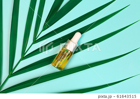 bottle of essential oil on blue background 61643515
