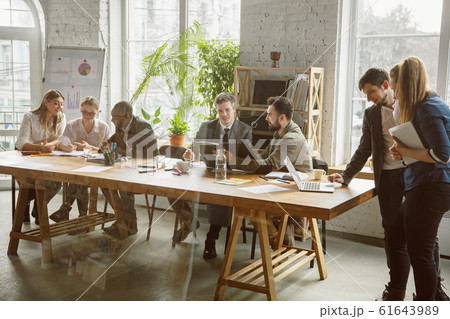 Group of young business professionals having a meeting, creative office Group of young business professionals having a meeting, creative office 61643989