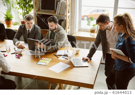 Group of young business professionals having a meeting, creative office Group of young business professionals having a meeting, creative office 61644013