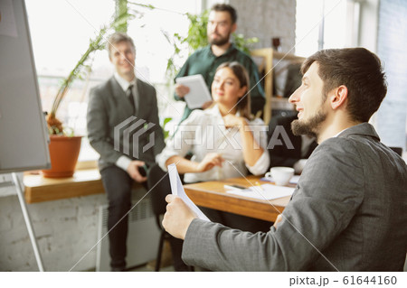 Group of young business professionals having a meeting, creative office Group of young business professionals having a meeting, creative office 61644160