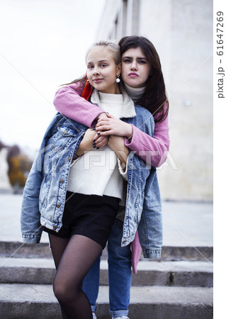 young happy students teenagers at university building on stairs, lifestyle people concept brunette and blond girl 61647269