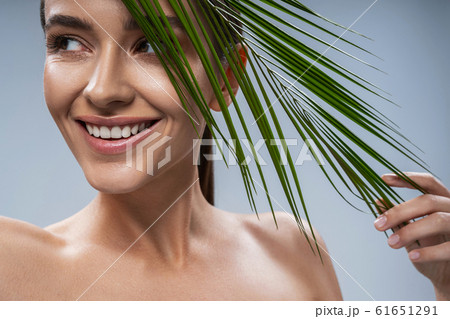 Caucasian happy girl posing for camera against grey background 61651291
