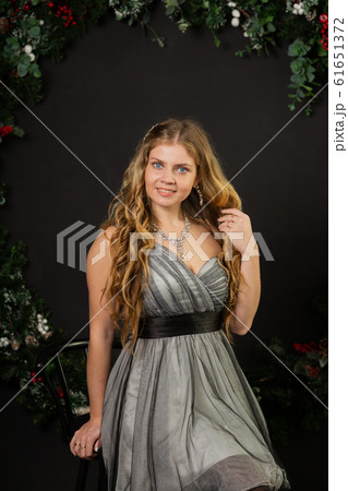 Girl in New Year's decor and a beautiful dress. Girl in New Year's decor and a beautiful dress. 61651372