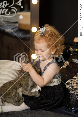 Beautiful little girl child on a New Year's bed 61651522