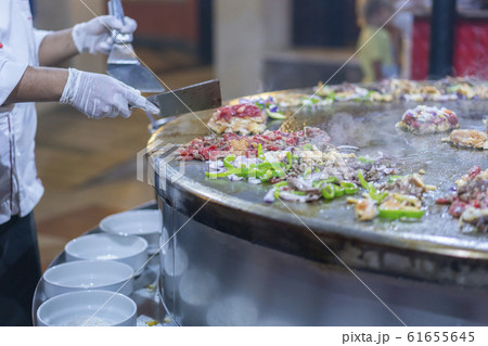 Cooking street food on a large firebox. Frying Cooking street food on a large firebox. Frying 61655645