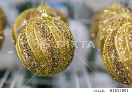 Yellow Christmas balls in a New Year's store. Yellow Christmas balls in a New Year's store. 61655691