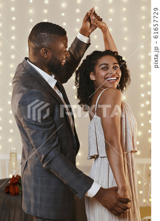 Portrait of beautiful black couple dancing in modern restaurant Portrait of beautiful black couple dancing in modern restaurant 61657729