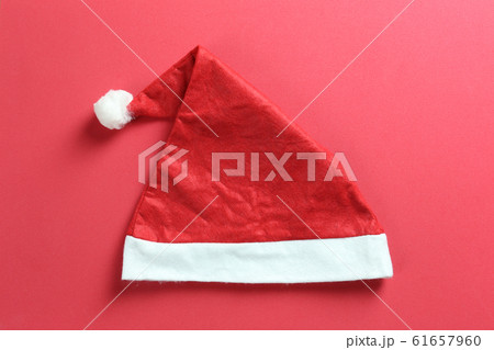 Santa hat on red art paper background. Santa hat on red art paper background. 61657960