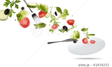 White plate with salad in flight: tomato, lattice, olives 61658252
