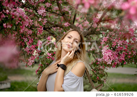 Portrait of a beautiful girl among spring foliage 61659926
