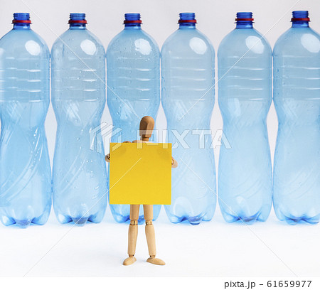 Wooden mannequin with banner trying to say no to plastic Wooden mannequin with banner trying to say no to plastic 61659977