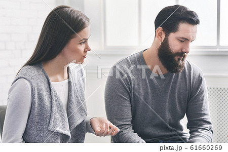 Disappointed wife blaming her depressed husband at marriage counselling session 61660269