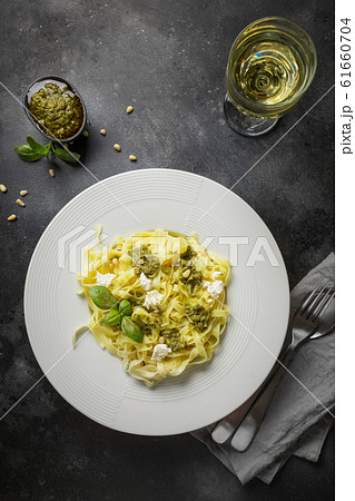 Pasta tagliatelle with pesto, pine nuts, wine Pasta tagliatelle with pesto, pine nuts, wine 61660704