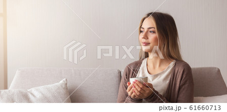 Dreamy girl enjoying hot fresh coffee at home Dreamy girl enjoying hot fresh coffee at home 61660713