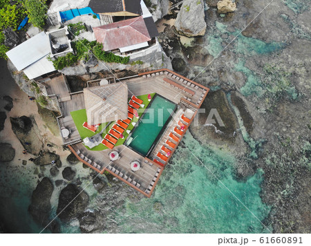 Aerial view of little surfer village on the rock cliff and coastline. Aerial view of little surfer village on the rock cliff and coastline. 61660891