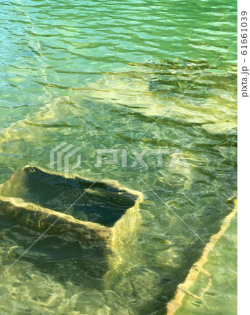 Abandoned boat in flooded quarry with blue crystal water. Abandoned boat in flooded quarry with blue crystal water. 61661039
