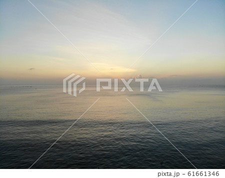 Sunset over the ocean in Bali 61661346