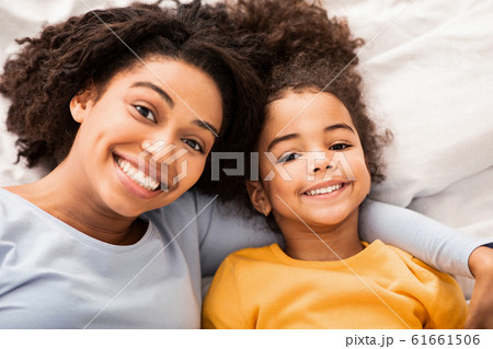 Afro Mother And Daughter Lying In Bed In Bedroom, Top-View 61661506