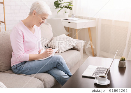 Well organized senior lady writing to-do-list at home Well organized senior lady writing to-do-list at home 61662262