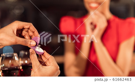 Unrecognizable Boyfriend Showing Engagement Ring To Girlfriend In Restaurant, Panorama Unrecognizable Boyfriend Showing Engagement Ring To Girlfriend In Restaurant, Panorama 61662463