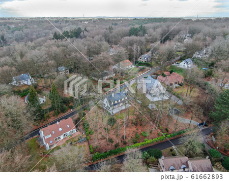 Aerial view of big villas with garden surrounded by forest during winte season 61662893