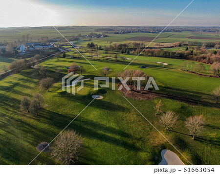 Aerial view of a golf course during autumn season Aerial view of a golf course during autumn season 61663054