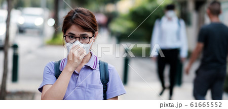 young Asian woman wearing N95 respiratory mask 61665552