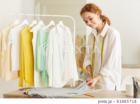 New collection. Tailor cutting fabric with scissors New collection. Tailor cutting fabric with scissors 61665718