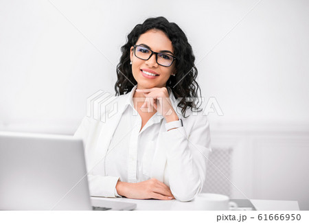 Mexican recruiter looking at camera with hand on chin Mexican recruiter looking at camera with hand on chin 61666950