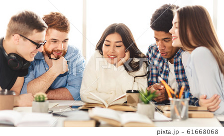 Happy group of students reding book in library Happy group of students reding book in library 61668068
