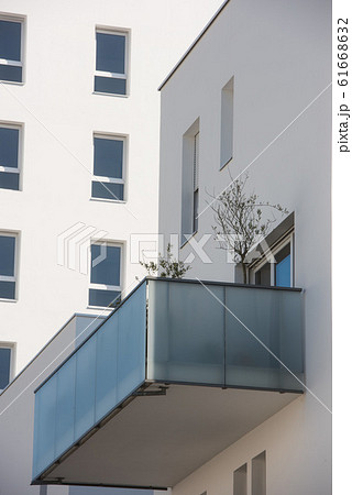 Modern concrete balcony s in a cut out on blue sky 61668632