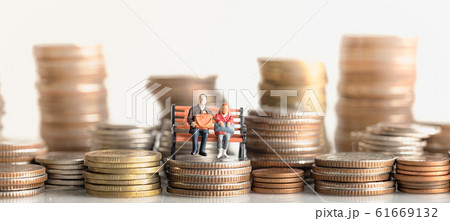 lderly people sitting on coins stack. lderly people sitting on coins stack. 61669132