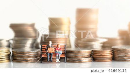 lderly people sitting on coins stack. lderly people sitting on coins stack. 61669133