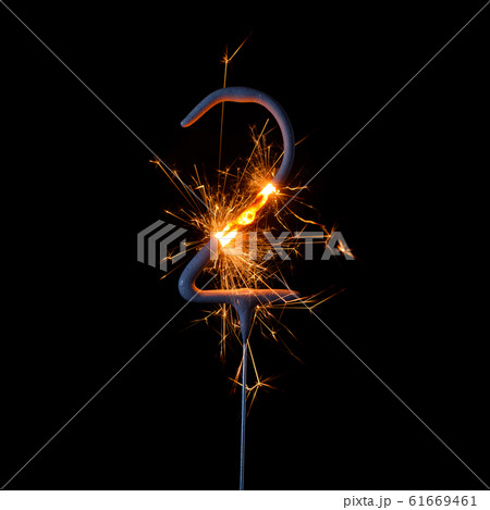 Burning sparkler in shape of number two, digit 2, isolated on black background. Burning sparkler in shape of number two, digit 2, isolated on black background. 61669461