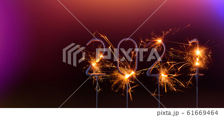 Happy New Year 2021 banner template. Digits of year 2021 made by burning sparklers isolated. 61669464
