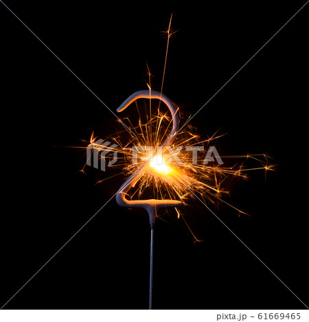 Burning sparkler in shape of number two, digit 2, isolated on black background. Burning sparkler in shape of number two, digit 2, isolated on black background. 61669465