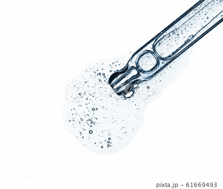 Clear serum in pipette isolated on white background. Cosmetic liquid dropper with bubbles top view. Clear serum in pipette isolated on white background. Cosmetic liquid dropper with bubbles top view. 61669493