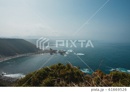 Misty rocky ocean coast line 61669526