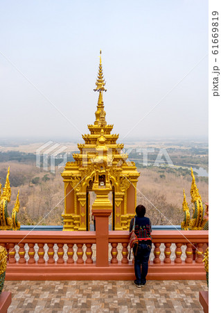 Female tourist at Wat Phra That Doi Phra Chan on the top of mountain in Mae Tha District Female tourist at Wat Phra That Doi Phra Chan on the top of mountain in Mae Tha District 61669819
