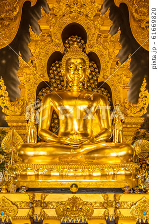 Ancient golden Seated Buddha Statue (with the name at the base) in Wat Phra That Doi Phra Chan on the top of mountain in Mae Tha District 61669820